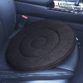 Grey round cushion in the driver's seat of a car
