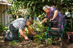 Older couple gardening using AT